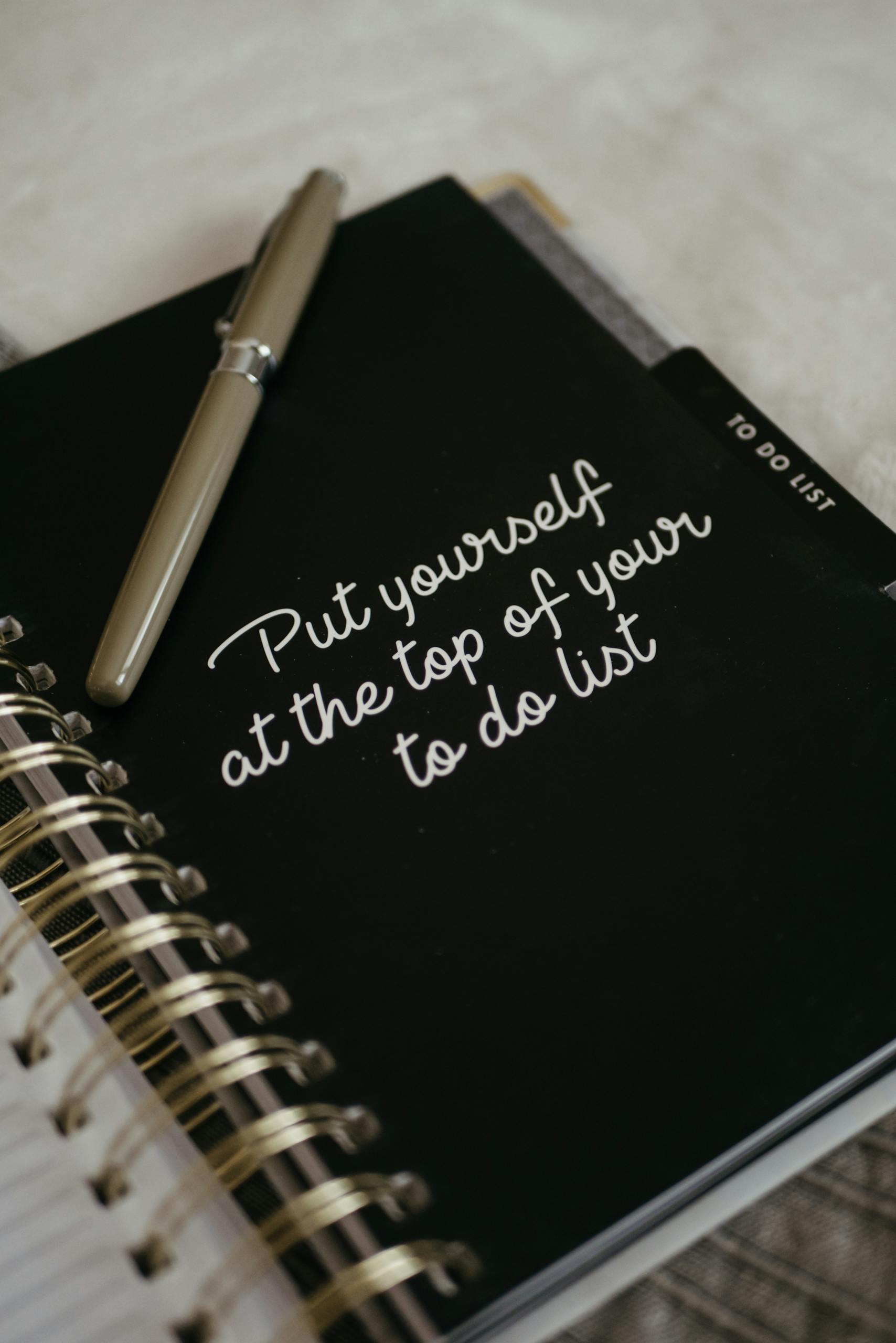 Prioritizing: Close-up of a notebook with an inspirational message to prioritize yourself.
