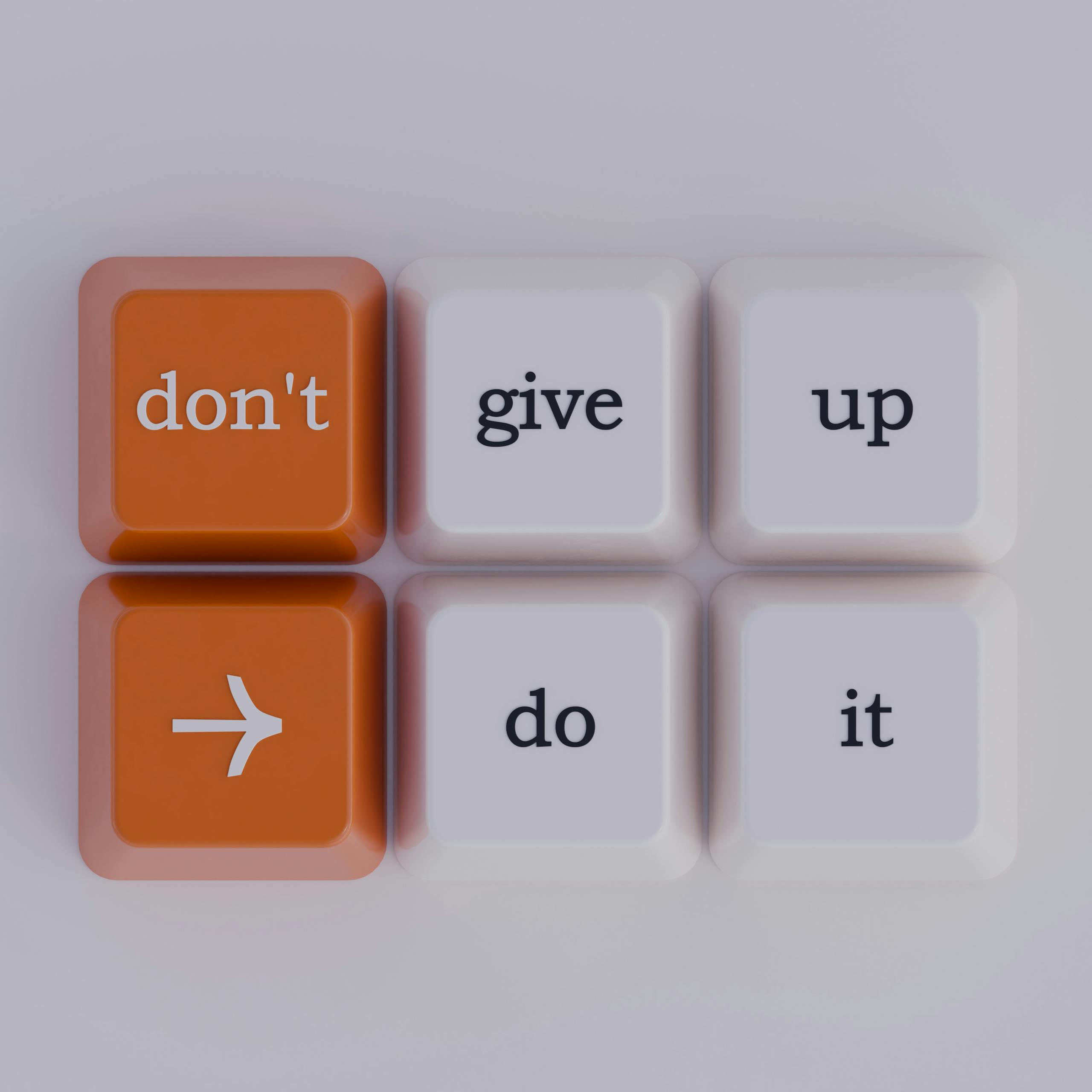 Resilient business, Keyboard keys spelling out 'don't give up' message, simple and inspiring.