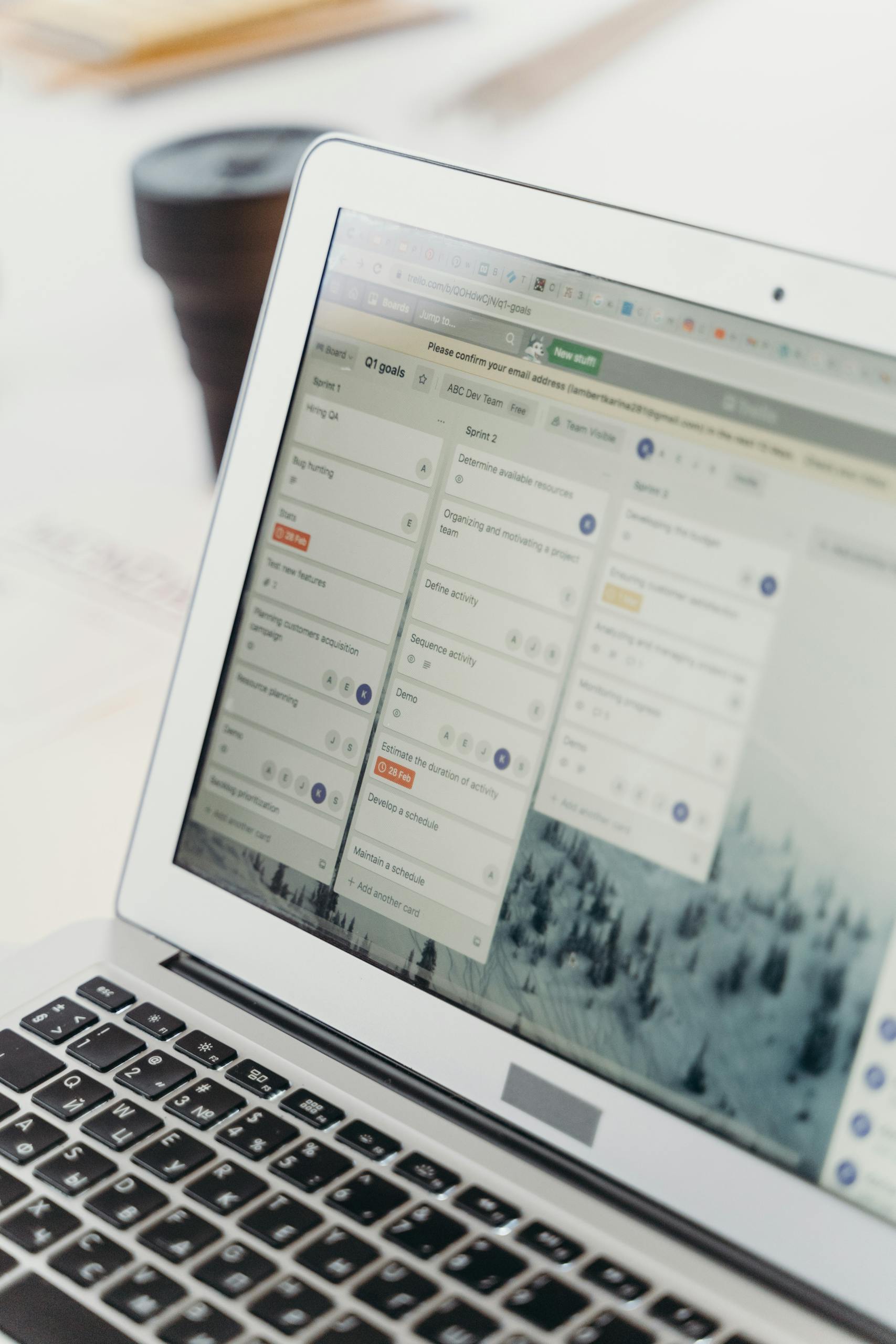tracking tools: Close-up of a laptop screen showing project management software interface. Perfect for business or tech themes.
